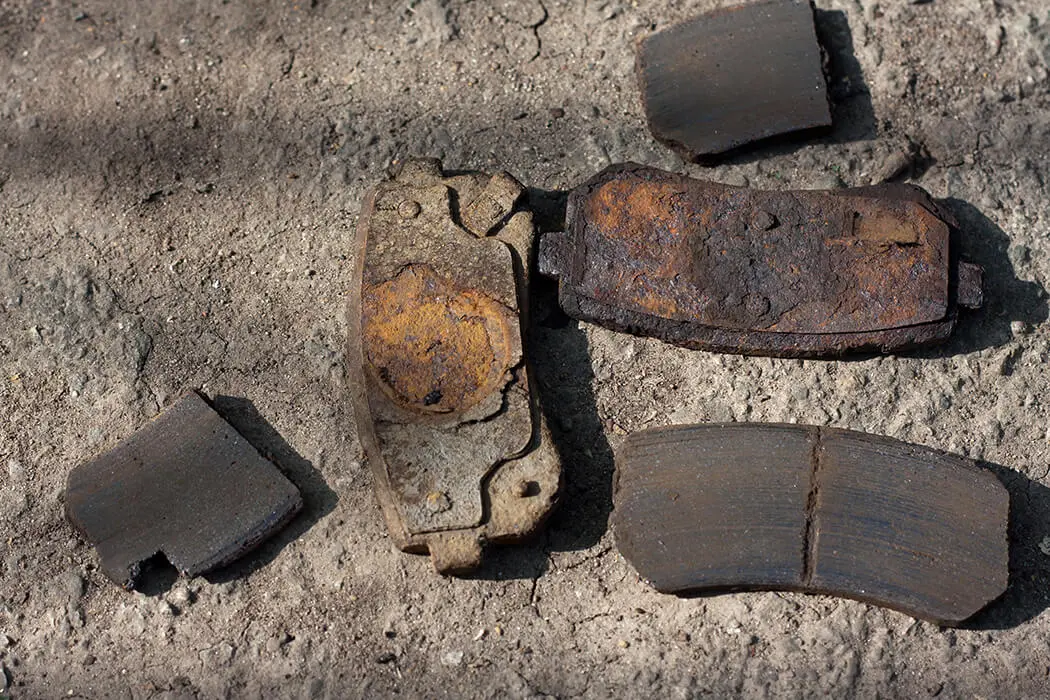 Broken, rusted, and completely worn brake pads